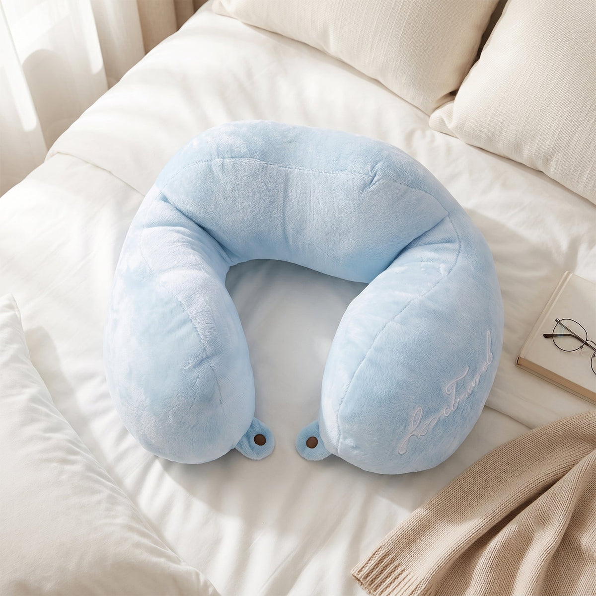 Blue plush neck cushion for flights, cars and trains